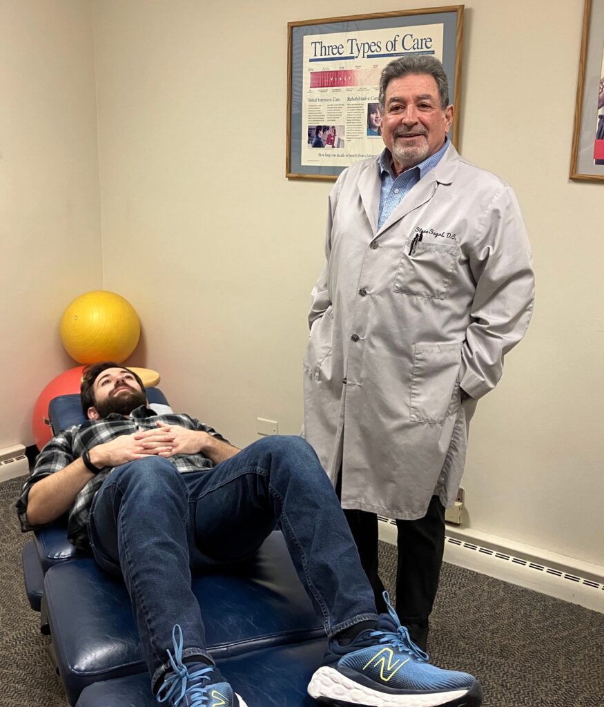 Dr. Steve Segal, Libertyville chiropractor, preparing to perform a chiropractic adjustment for back pain relief.